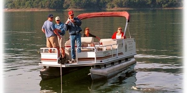 A group of people on a boat in the water.